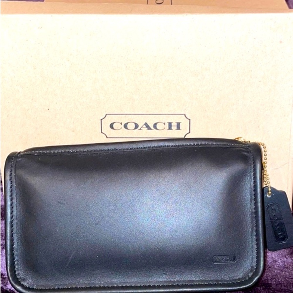 New, Coach zippered leather black make up bag, clutch/pouch and comes in box.